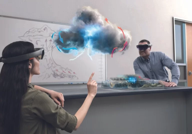 A student and professor using HoloLens to show a weather hologram in a class.