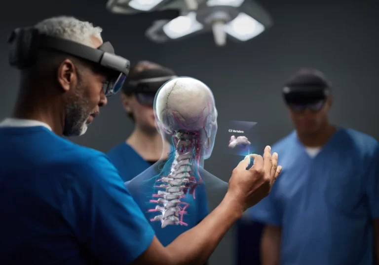 A doctor showing his fellow practitioners a hologram of a head through a HoloLens.